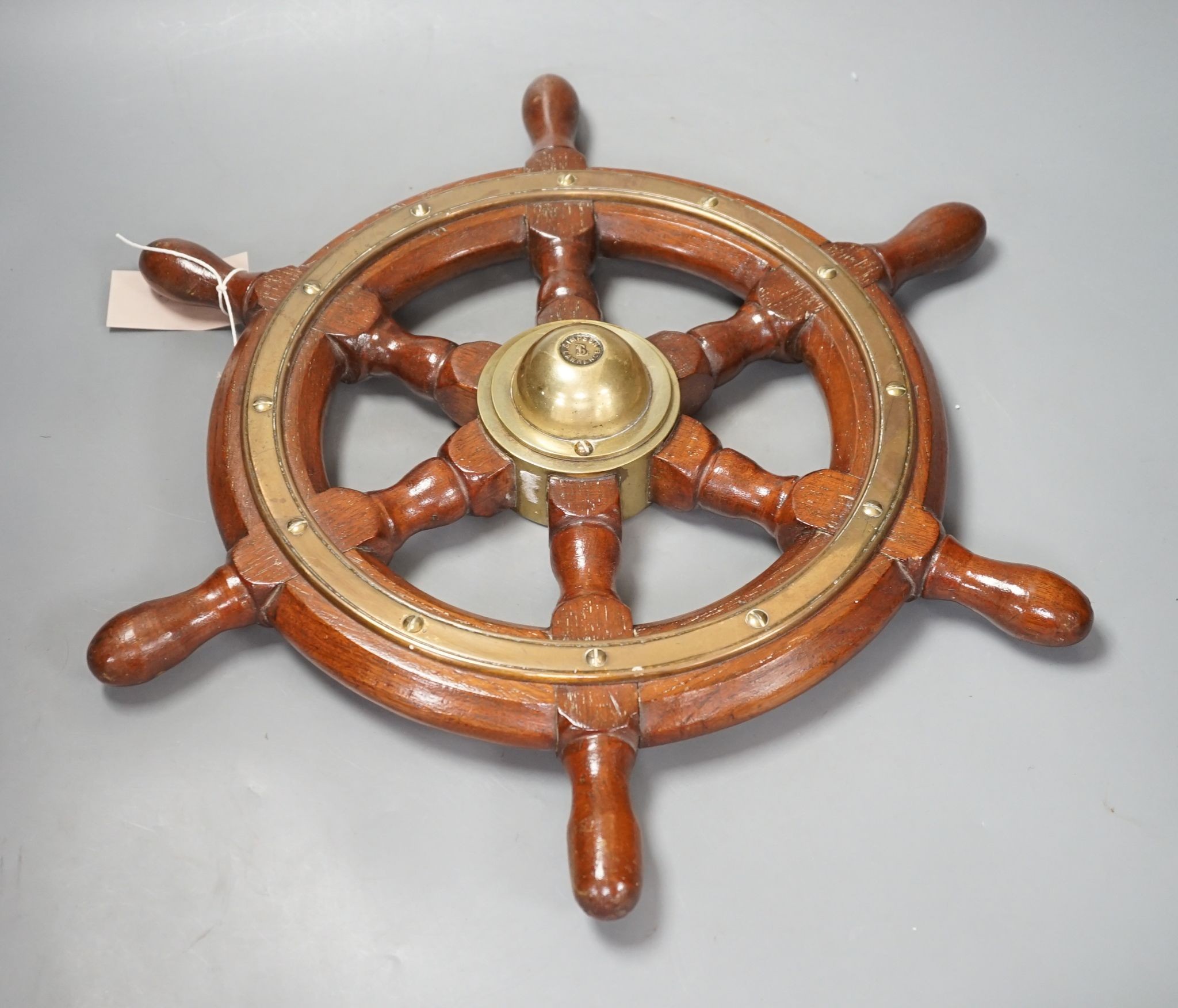 A teak and brass mounted Ship's wheel signed Lawrence Simpson 47cm